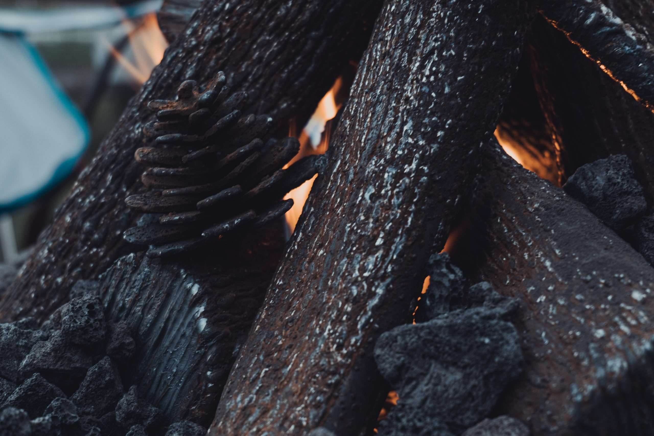 Handcrafted steel logs radiating heat in a custom fire pit