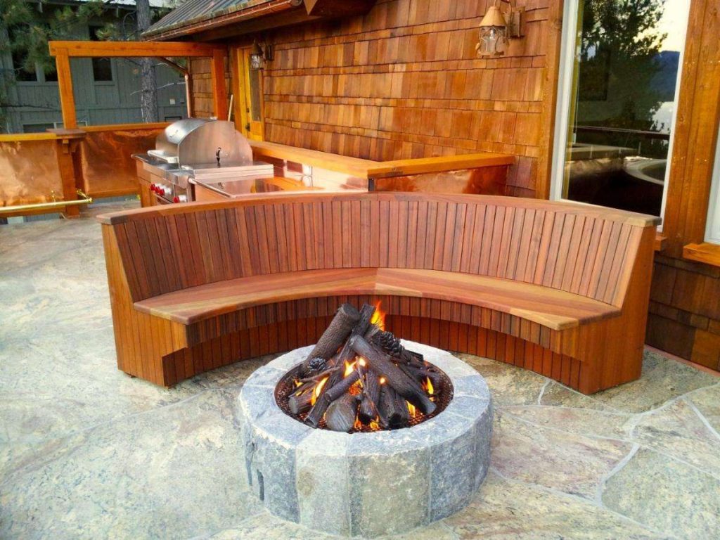 Custom fire pit with built-in bench seating in an outdoor living space