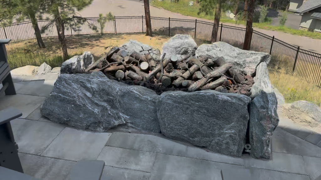 Modern minimalist black steel custom fire pit on a contemporary patio