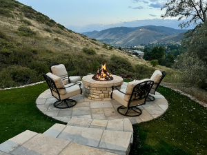 Custom steel fire pit centerpiece in a luxury mountain backyard at dusk